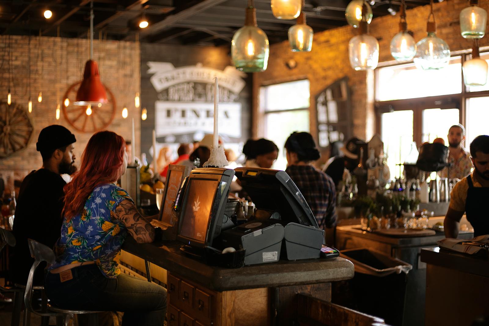 A bustling café in Miami with people enjoying a lively atmosphere and stylish interior design.